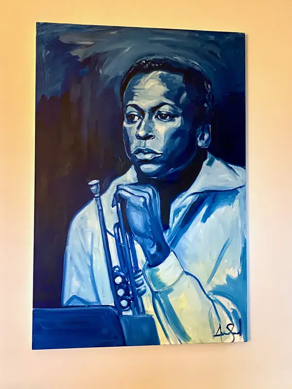 Blue-toned painted portrait of Miles Davis with his trumpet